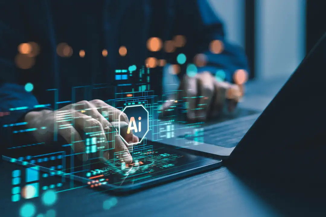Hands using laptop and tablet with AI interface visuals, representing advanced computing powering Sweden’s Mimer AI factory